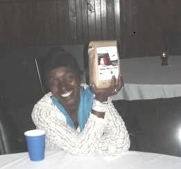 Patricia Wynter with her door prize, our new Stories in the North coffee-blend, Looming Deadline.